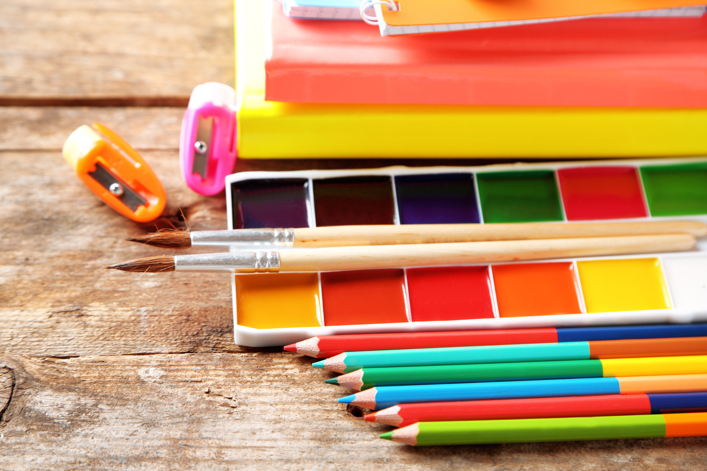 Multi-Colored School Stationery and Art Supplies on Old Wooden Table